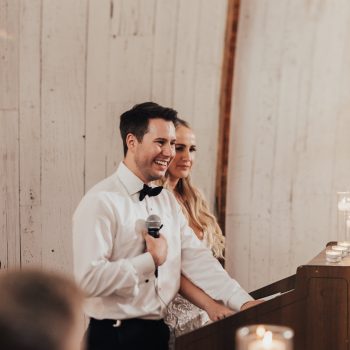 Bride and groom giving a heartfelt speech at their wedding reception.